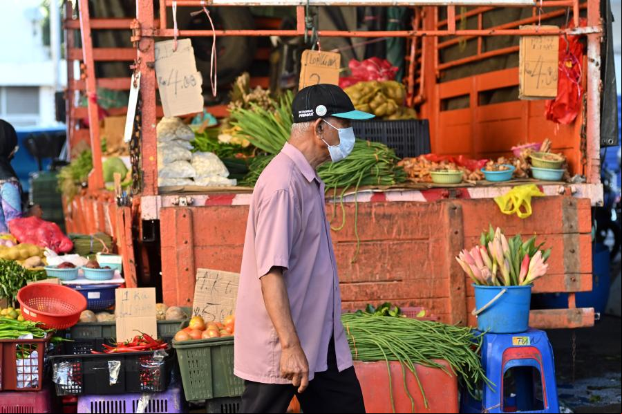 Personas portan mascarillas en Kuala Lumpur, Malasia